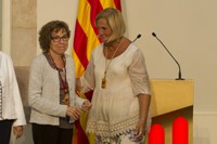 Maria Dolors Calvet rebent la Medalla d'honor del Parlament de la mà de Núria de Gispert