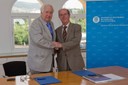 El rector de la UPC, Antoni Giró, i el president de la Fundación Laboral de la Construcción de Catalunya, Joan Santaulària, es donen la mà després de  la signatura del conveni, el 4 de juliol